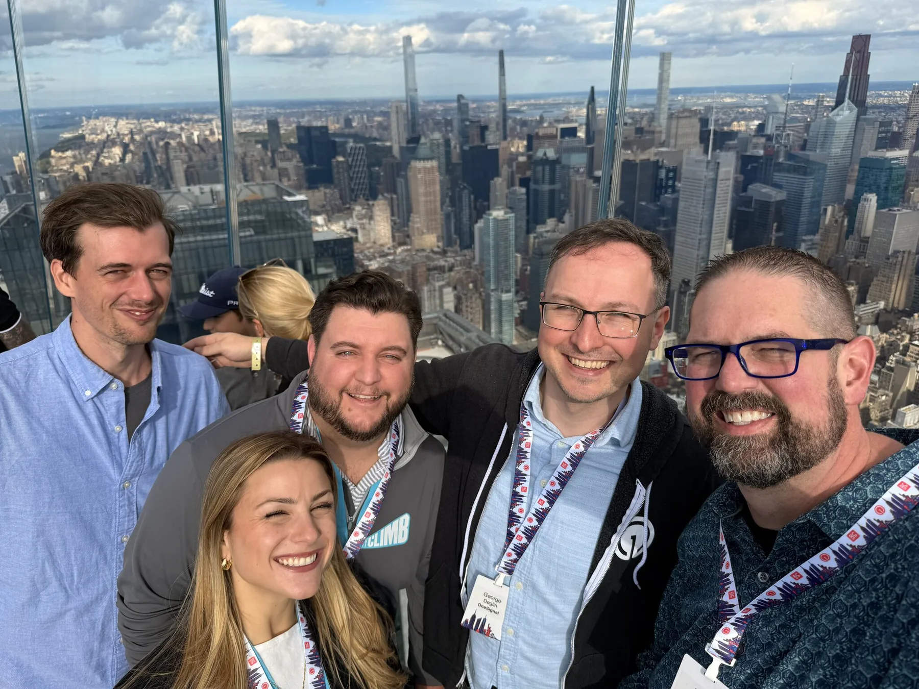 Guests at the OneSignal mixer at The Edge with the Manhattan skyline behind them