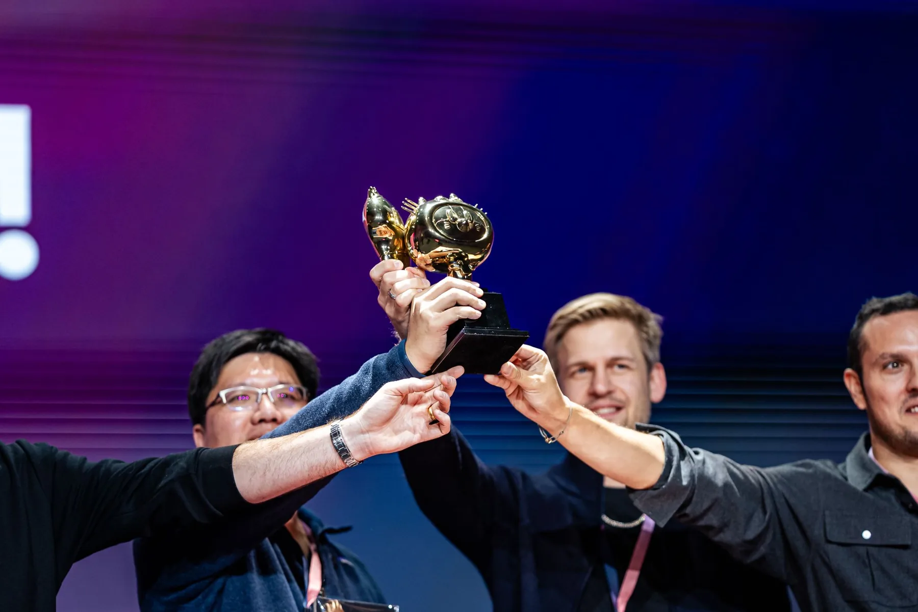 Attendees lifting the golden Shippy trophy on stage